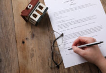 The Limited Shelf-Life of Your Will: Why Regular Estate Planning Reviews Matter Woman signing Last Will and Testament at wooden table, top view. Space for text